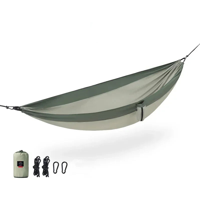 Nomad x Naturehike ultralight portable hammock hanging outdoors, ideal for camping and outdoor relaxation.