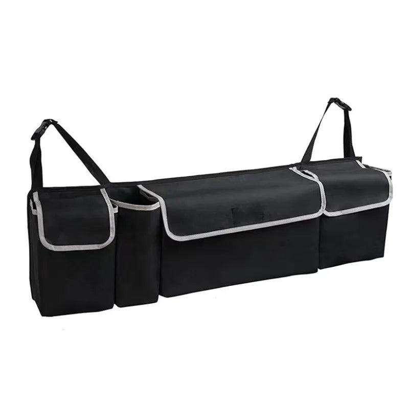 Nomad Trunk Elite hanging organizer in Oxford cloth with multiple pockets for SUV and hatchback storage, shown in vehicle trunk.