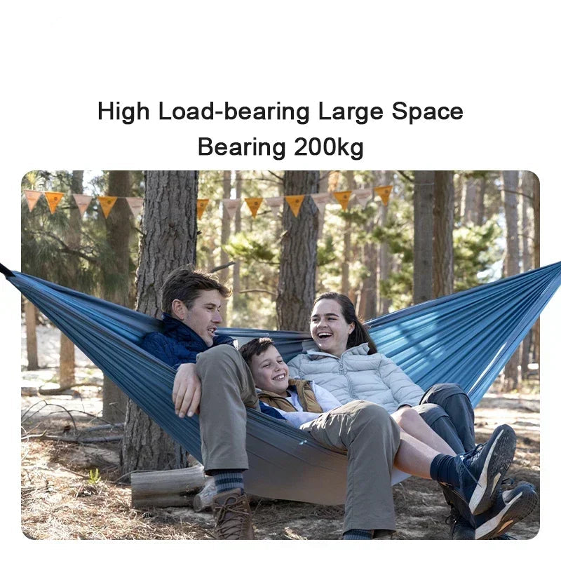 Nomad x Naturehike ultralight portable swing hammock displayed outdoors, showcasing its compact design and outdoor camping use.