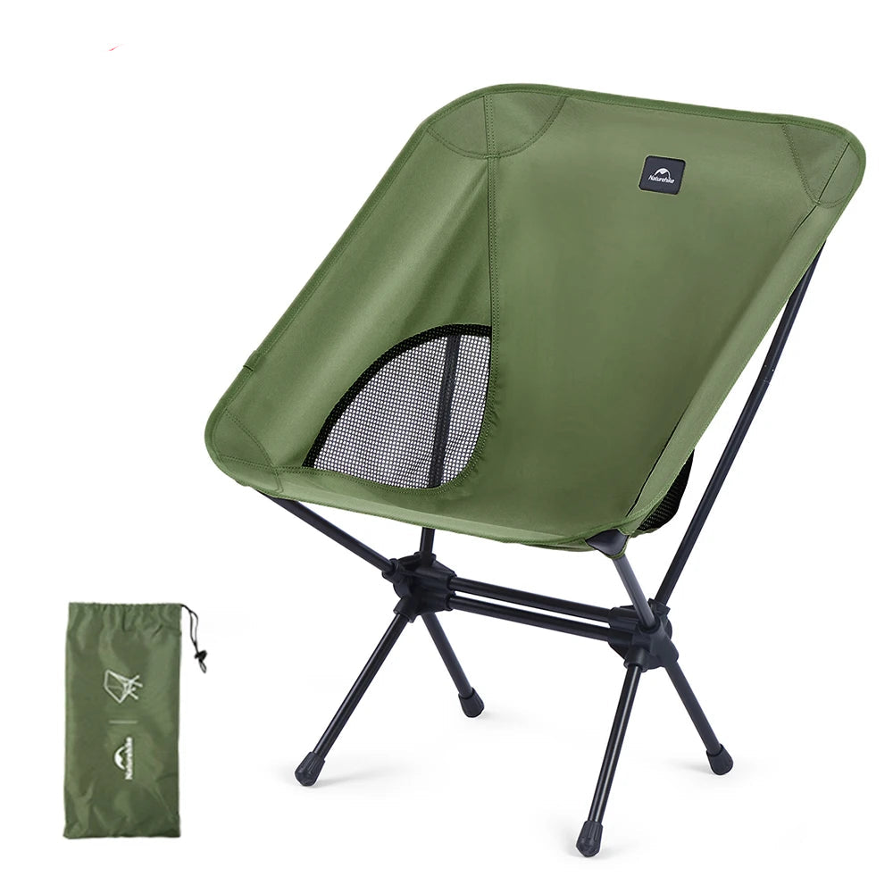 Nomad x Naturehike ultralight folding moon camping chair with aluminum frame and fabric seat, set up outdoors for camping.