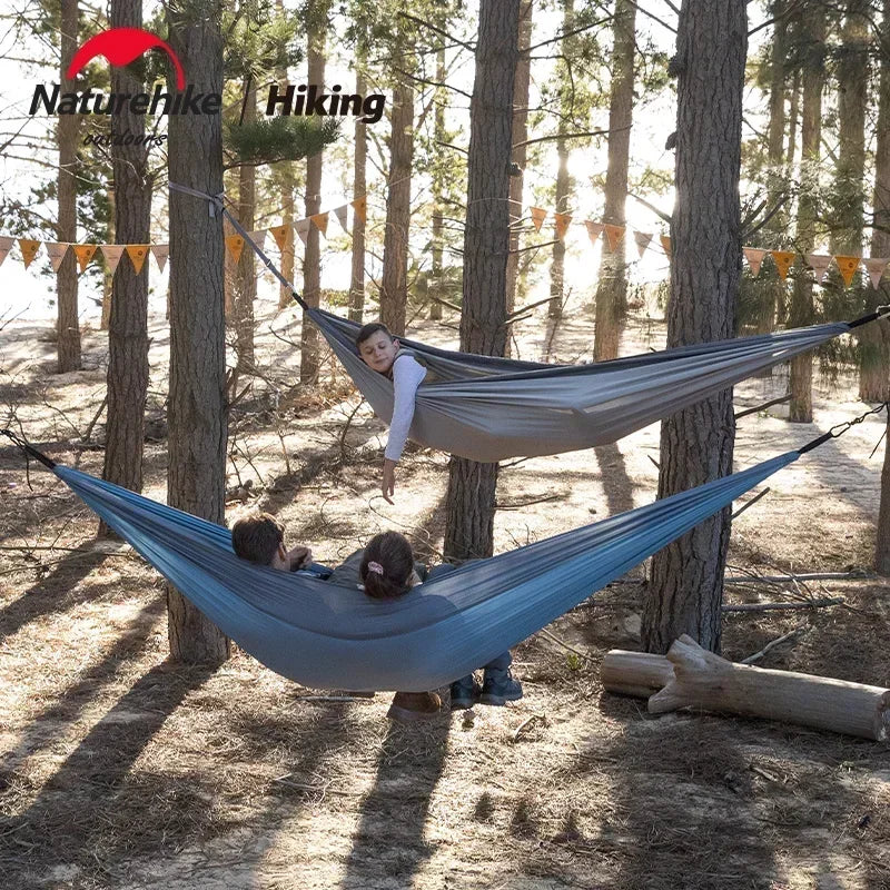 Nomad x Naturehike ultralight portable hammock hanging outdoors, ideal for camping and outdoor relaxation by Nomad Pacific Supply.